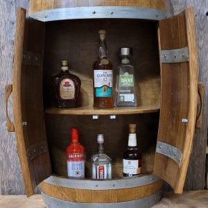 A barrel cabinet with two doors opened, revealing 6 bottles of alcohol stored neatly